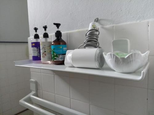 a shelf in a bathroom with toiletries on it at Cozy home@Friendship Garden 3 in Kota Kinabalu