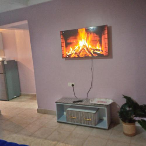 a living room with a fireplace on the wall at Verona Apartments in Thika