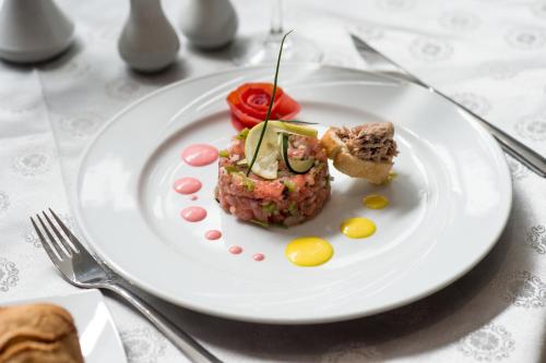 a white plate with a piece of food on a table at Hotel Toubkal in Casablanca