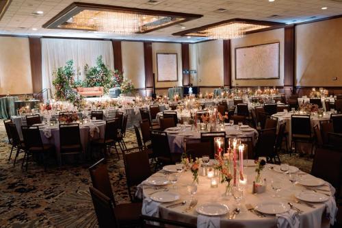 a banquet hall with tables and chairs with white tablecloths at Crowne Plaza Knoxville Downtown University by IHG in Knoxville