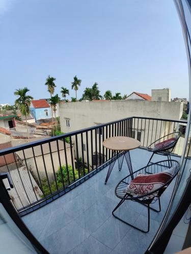 a view of a balcony with a table and a chair at The Dragon Villa Hoi An in Hoi An