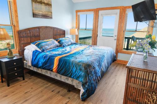 a bedroom with a bed with a view of the ocean at 23252 Rodanthe in Nags Head