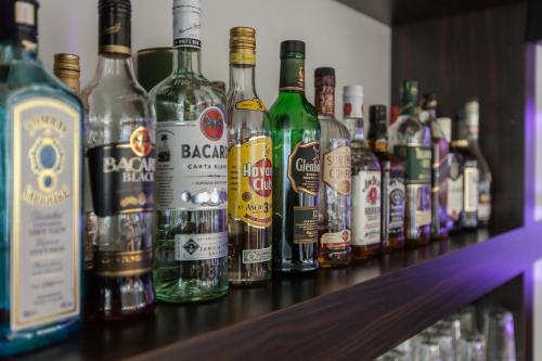 a row of bottles of alcohol sitting on a bar at Hotel am Fjord in Flensburg