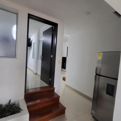 a hallway with a mirror and stairs in a house at LA CASA DEL CABLE - Hermoso Apartamento - in Manizales