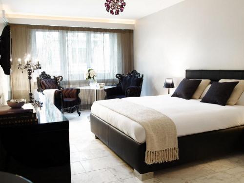 a bedroom with a large bed and a dining room at VISIONAPARTMENTS Freyastrasse - contactless check-in in Zurich