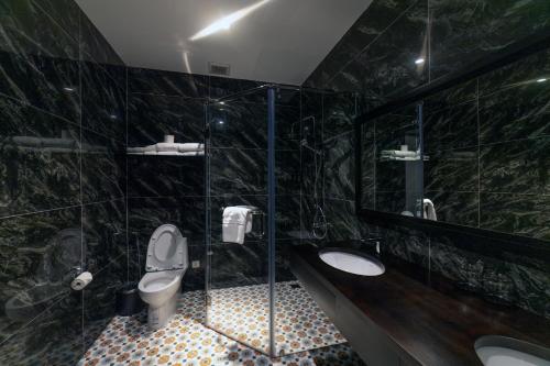 a bathroom with a toilet and a sink at Brick House Dalat Hotel in Da Lat