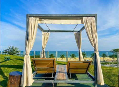 an outdoor wedding altar with a view of the ocean at Hotel Nacional in Rio de Janeiro