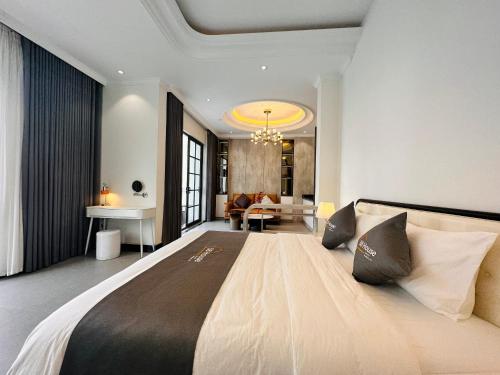 a bedroom with a large bed and a living room at 58 House - Mỹ Anh Homestay in Hai Phong
