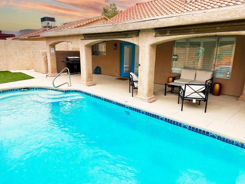 a swimming pool in front of a house at Mirage Pool House - Heart of LV, Swimming Pool, Games, heavenly relaxation in Las Vegas