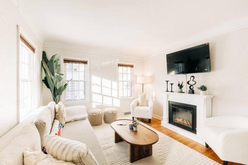 a living room with a couch and a fireplace at Enchanting and comfy urban cottage with renovated rustic den by Como Park & MN State Fair in Saint Paul