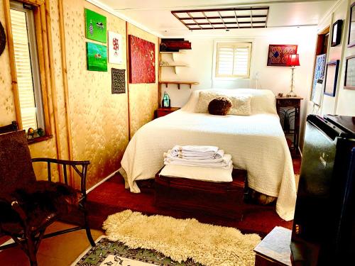 Sedona Camp Tiny House في سيدونا: غرفة نوم بسرير ولحاف ابيض