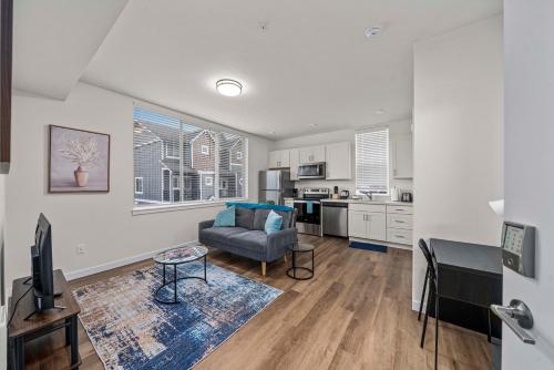 a living room with a couch and a kitchen at Urban Living: Stylish Apts in the Heart of Tacoma in Tacoma