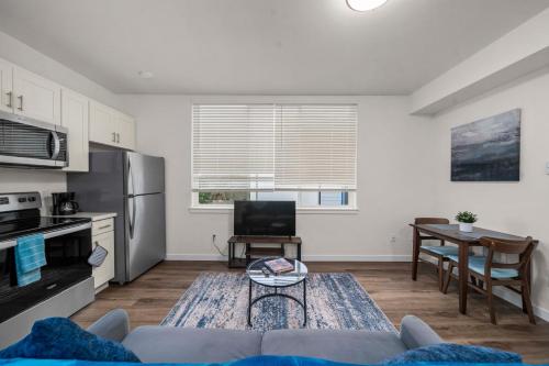 a living room with a couch and a table at Urban Living: Stylish Apts in the Heart of Tacoma in Tacoma