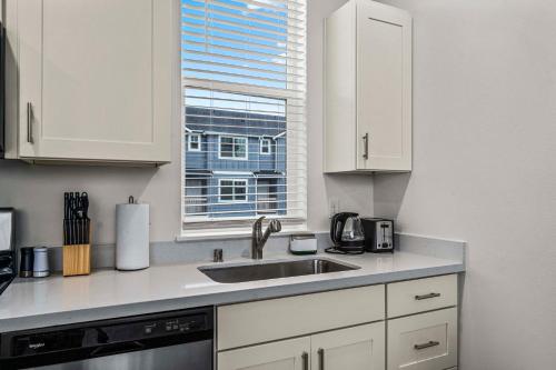 a kitchen with a sink and a window at Urban Living: Stylish Apts in the Heart of Tacoma in Tacoma