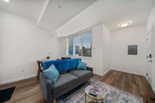 a living room with a couch and a table at Urban Living: Stylish Apts in the Heart of Tacoma in Tacoma