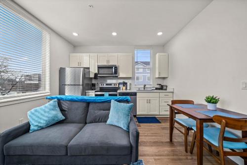 a living room with a couch and a table at Urban Living: Stylish Apts in the Heart of Tacoma in Tacoma