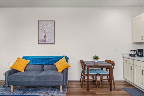 a living room with a couch and a table at Urban Living: Stylish Apts in the Heart of Tacoma in Tacoma