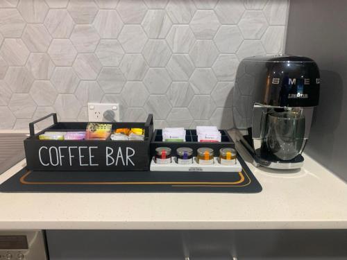 a coffee bar sitting on top of a counter at Corrigans Beach View Apartment 211 in Batehaven