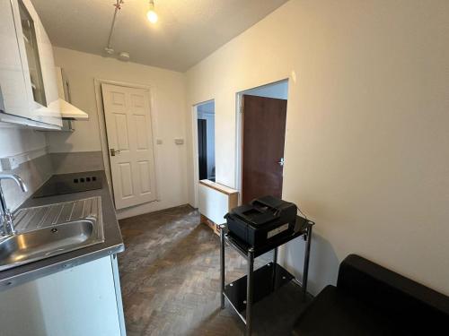 a small kitchen with a sink and a counter at The Hyde Arms in Edmonton