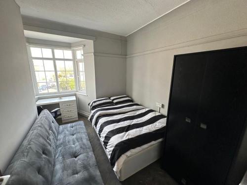 a bedroom with three beds and a window at The Hyde Arms in Edmonton