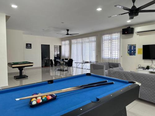 a living room with a pool table with cuesticks at 2 JB Adda Daya Setia Eco Austin 24paxs Pool Table in Johor Bahru