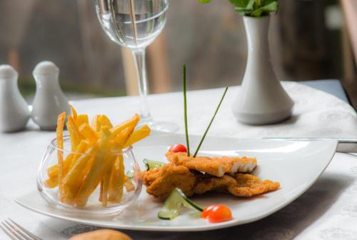 a plate of food on a table with french fries at Hotel Toubkal in Casablanca