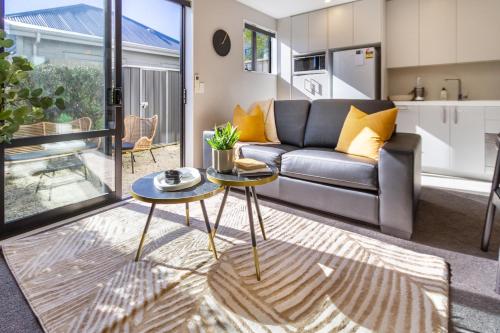 a living room with a couch and a table at Luxury Without Limits in CBD Christchurch in Christchurch