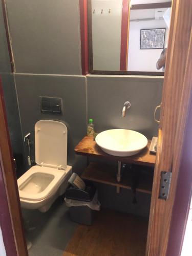 a small bathroom with a toilet and a sink at Newari homestay in Pātan