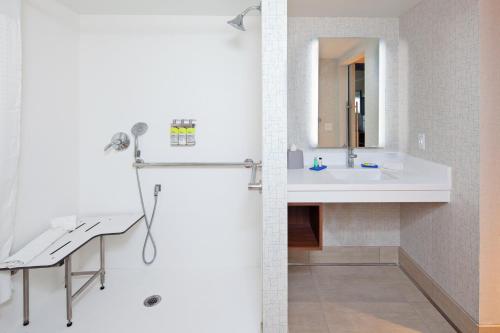 a white bathroom with a sink and a mirror at Holiday Inn Express Hotel & Suites Ventura Harbor, an IHG Hotel in Ventura