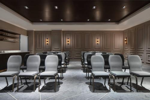 a conference room with rows of chairs and a podium at Lagos Marriott Hotel Ikeja in Lagos