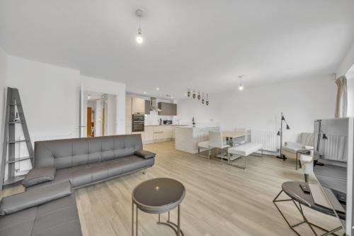 a living room with a couch and a table and a kitchen at 3 bedroom house in Bricket wood, St Alban in Garston