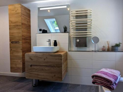 a bathroom with a sink and a mirror at Old Forge Modern Retreat 