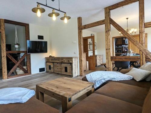 a living room with a couch and a table at Old Forge Modern Retreat 