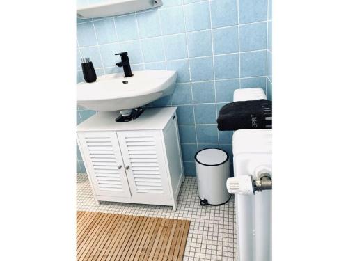 a bathroom with a sink and a toilet at Sea air Modern retreat in Wangerooge
