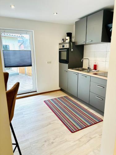 a kitchen with stainless steel appliances and a large window at Studio Reichenstrasse in Quedlinburg