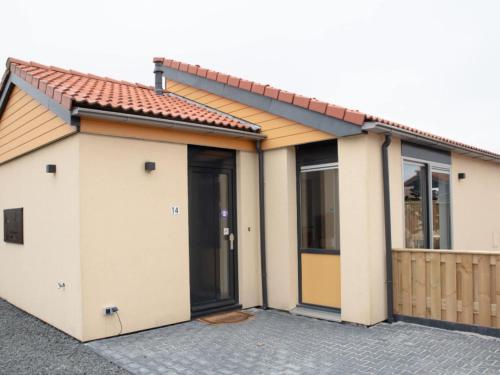 a house with two doors and a fence at Holiday Home in Zevenhuizen with Sauna Bubble Bath in Zevenhuizen