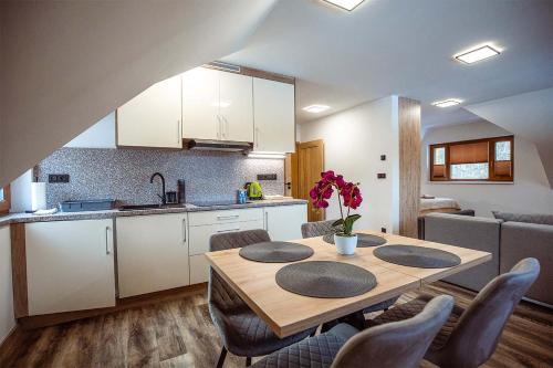 a kitchen and dining room with a table and chairs at Chalupa U Myslivce in Dolní Lomná
