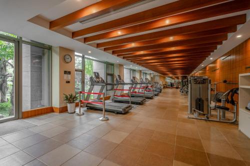 a gym with a row of treadmills and machines at InterContinental Kunming by IHG in Kunming