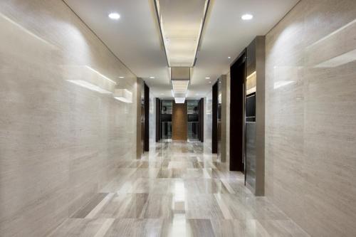a hallway of a building with wooden floors and ceilings at Hotel Santika Premiere Hayam Wuruk Jakarta in Jakarta