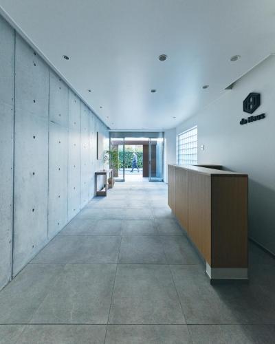 a hallway of a building with a reception desk at da Haus Shinjuku in Tokyo