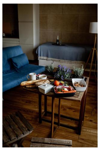 a living room with a table with food on it at Pērlerada room in Engure