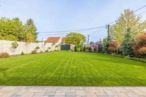 a large yard with a green lawn at Casa PERLA in Dunajská Streda