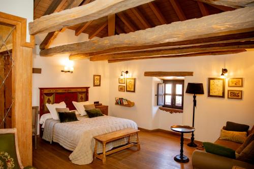 a bedroom with a bed in a room with wooden ceilings at Via Avis in Santa Catalina de Somoza