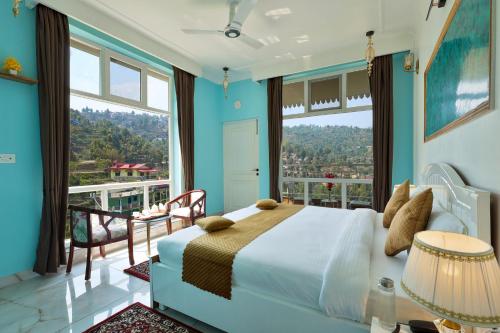 a bedroom with a large bed and a large window at The Crosswoods Three in Mukteswar