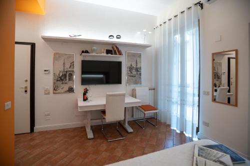 a room with a desk and a television in it at Indipendent Studio Apartment with Terrace - Parking in Florence