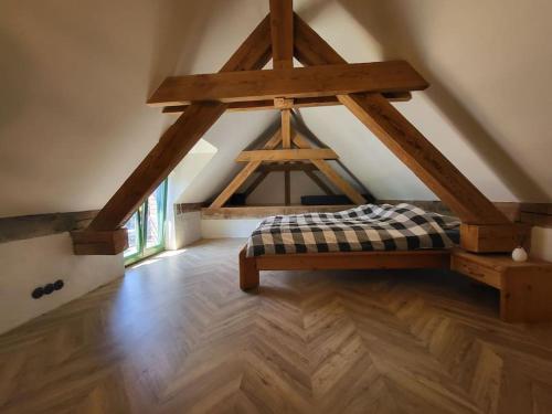 Camera mansardata con letto e pavimenti in legno. di Domek pod Klonem a Lubliniec