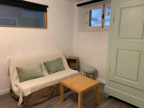 a room with a couch and a table and a window at le gite de la beaume in Rosières