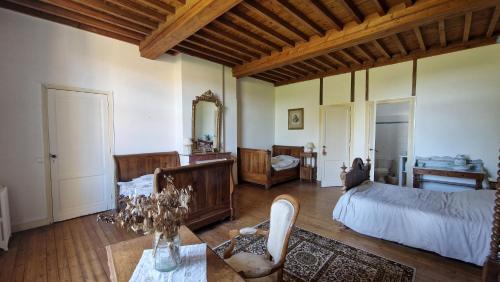 La Maison du Séguy في Saint-Ciers-de-Canesse: غرفة كبيرة بها سرير وطاولة