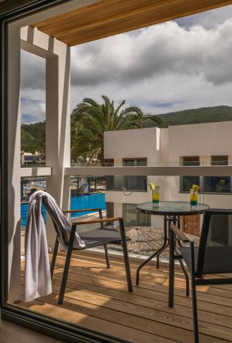a balcony with a table and a chair on a deck at Samara Hotel Bodrum Ultra All Inclusive in Torba