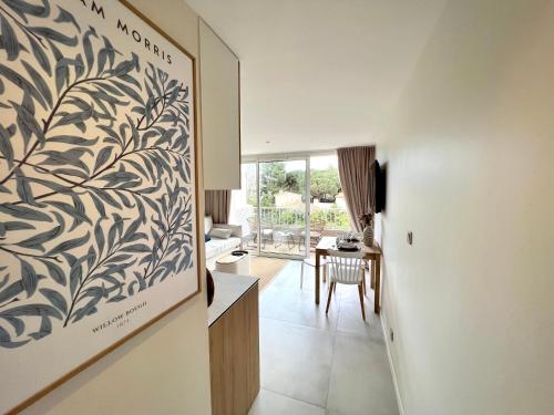 a living room with a painting on the wall at Saint Cyprien, superbe appartement calme proche du port, parking in Saint-Cyprien